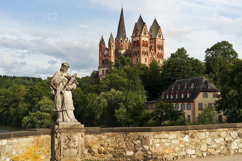The statue of St. Nepomuk on the Alte Lahnbrucke bridge with the late Romanesque and early Gothic Limburg Cathedral of Sankt Georg