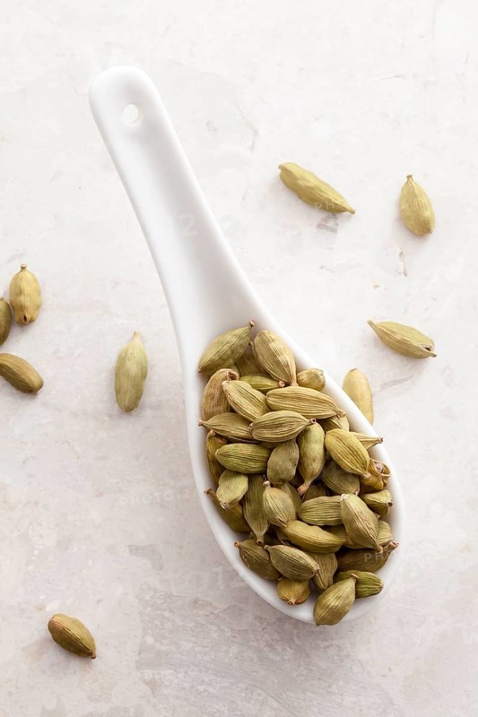 Cardamom pods on a spoon