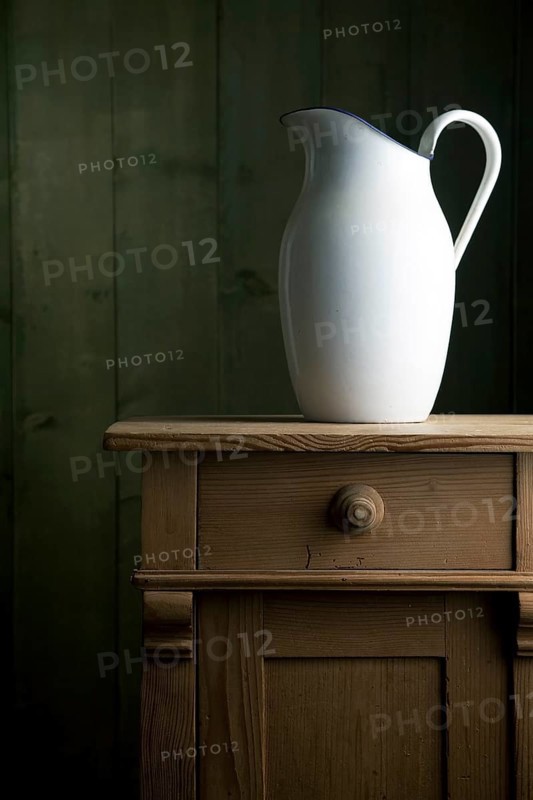 Old enamel jug on a small chest of drawers