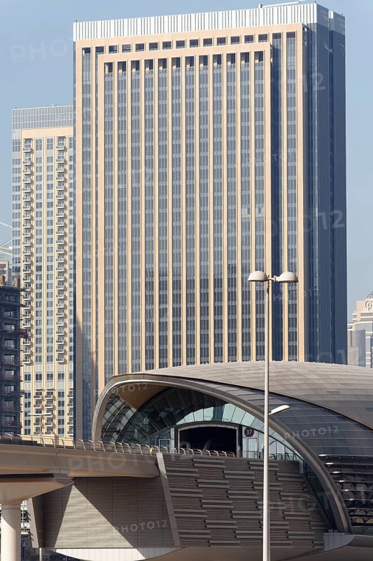 Jumeirah Lake Towers Metro Station in front of a skyscraper