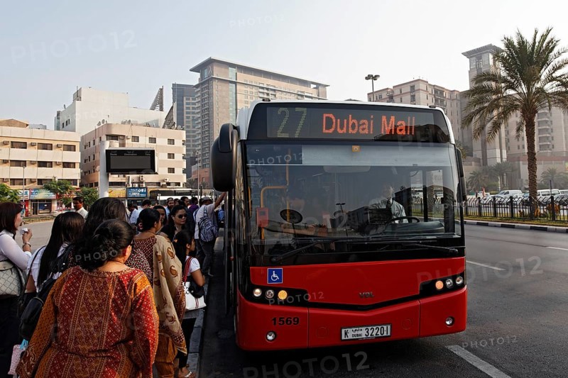 People getting on a bus to Dubai Mall