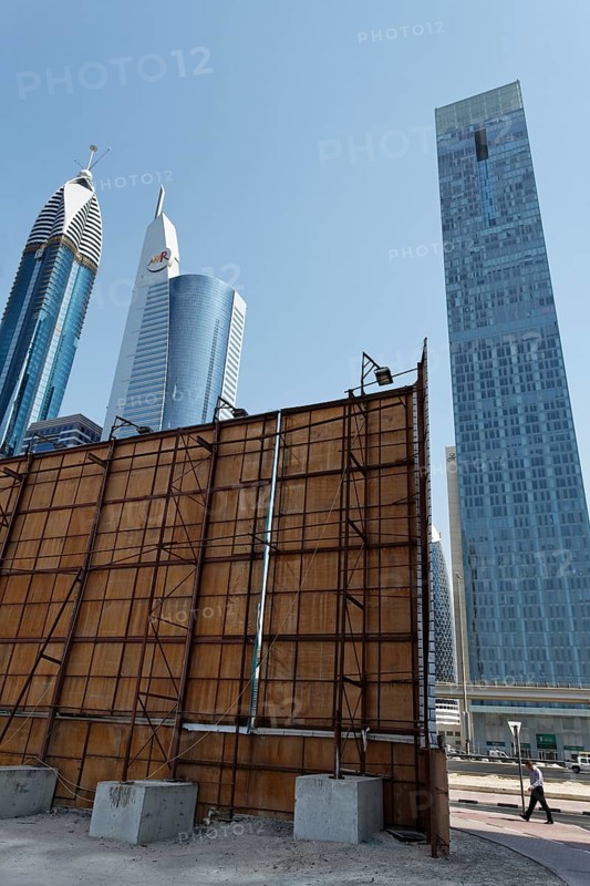 Construction site with a wooden partition in front of the skyline