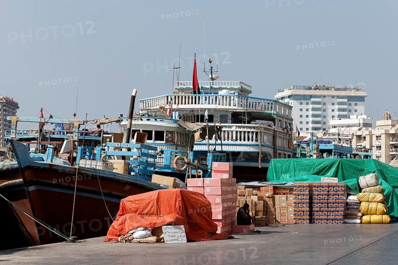 Cargo in front of an old wooden cargo ship