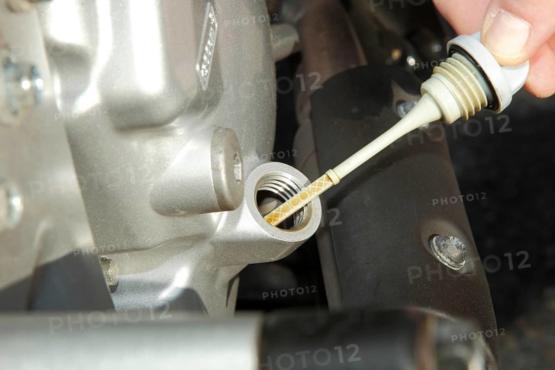 Checking the oil of a motor scooter