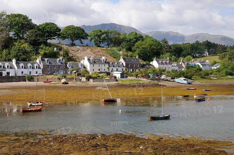 Boats grounded at low tide in a small fishing village