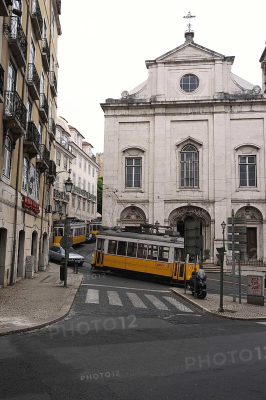 Three trams near a church