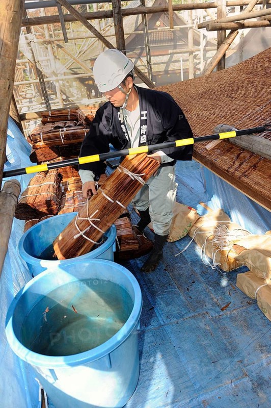 Cypress bark is soaked in water prior to thatching