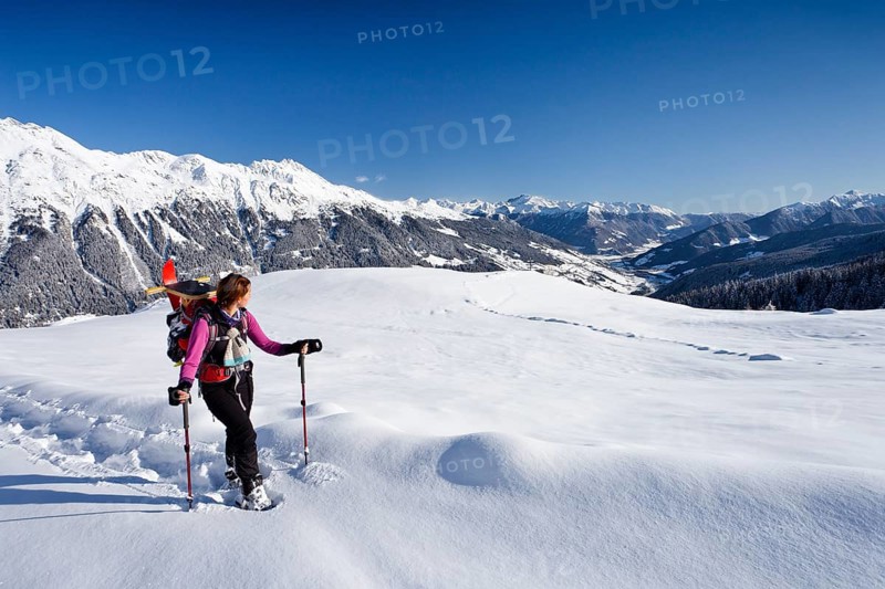 Snowshoe hiker during the ascent to Jagelealm alpine pasture
