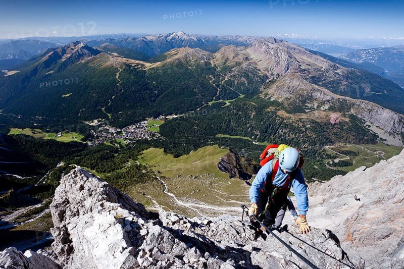 Mountaineers while climbing the Via Ferrata Bolver-Lugli climbing route on Cima Vezzena Mountain in the Pala Group