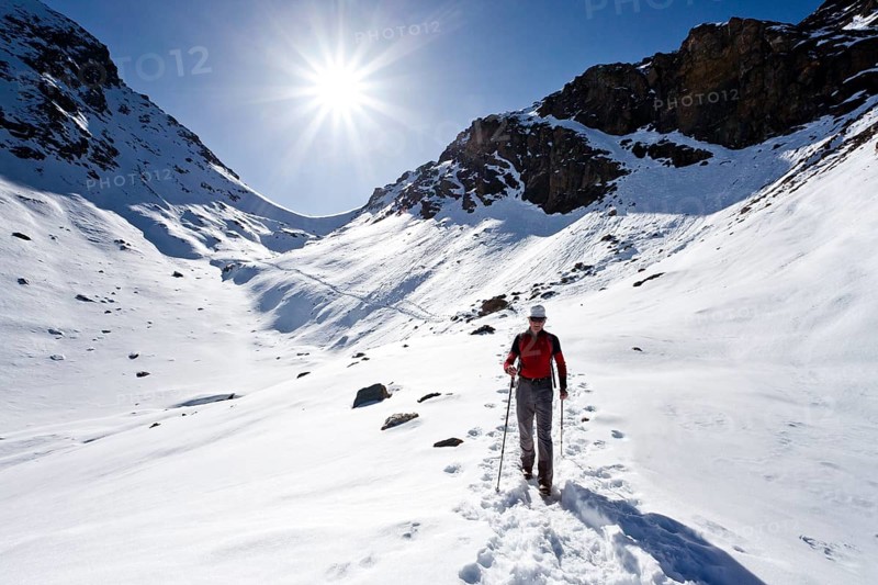 Mountain climber descending from Wilde Kreuzspitze Mountain in the Pfunderer Mountains