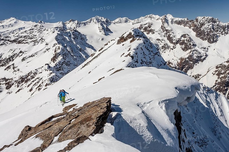 Ski walkers on the summit ridge with snowdrift