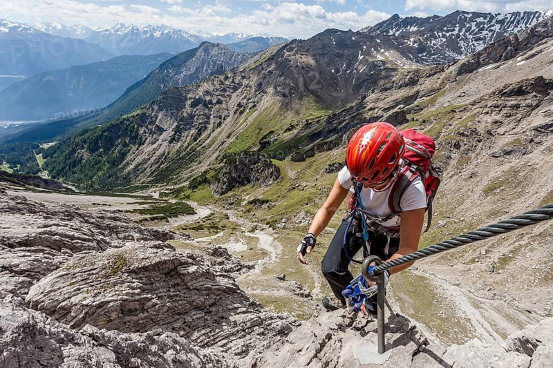 Mountaineer asceding through the Imster Klettersteig ferrata on the Maldonkopf in the Lech Valley Alps