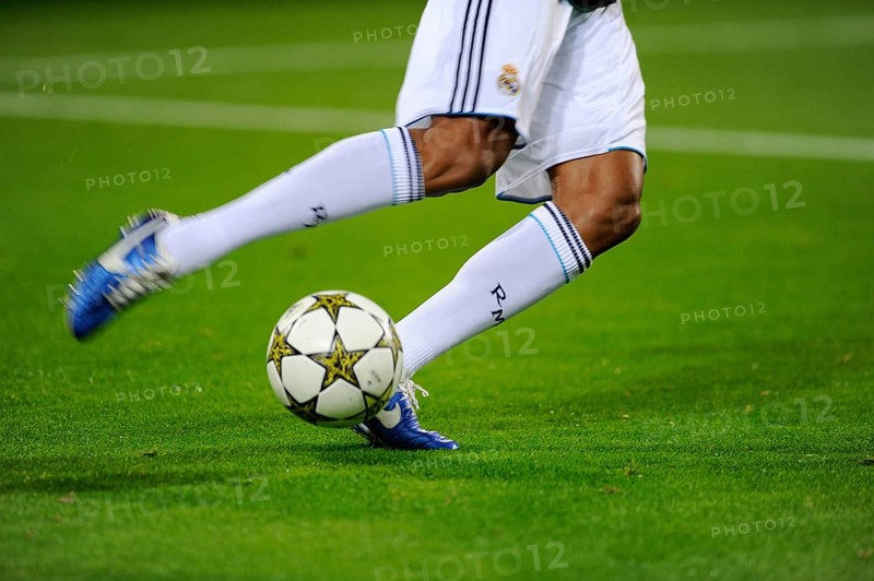 Real Madrid player running after the official match ball