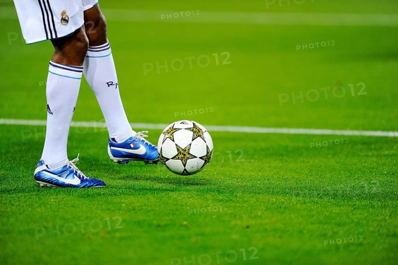 Real Madrid player running after the official match ball
