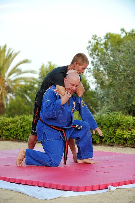 Two men doing martial arts training in a park