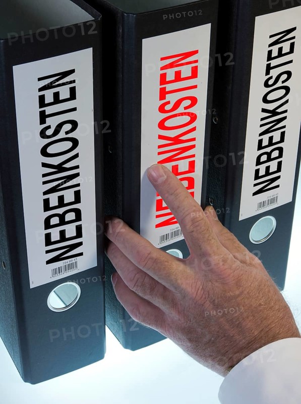 Hand reaching for a file folder labeled "Nebenkosten"