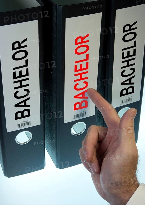 Hand pointing to a file folder labeled 'Bachelor'