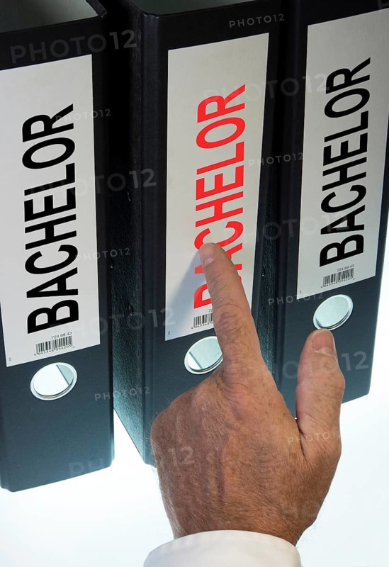 Hand pointing to a file folder labeled 'Bachelor'