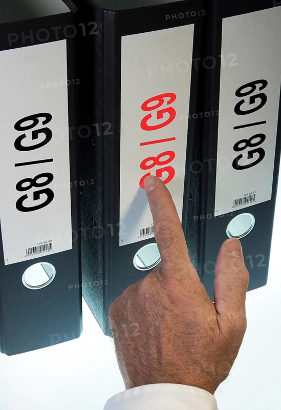 Hand pointing to a file folder labeled 'G8 - G9'