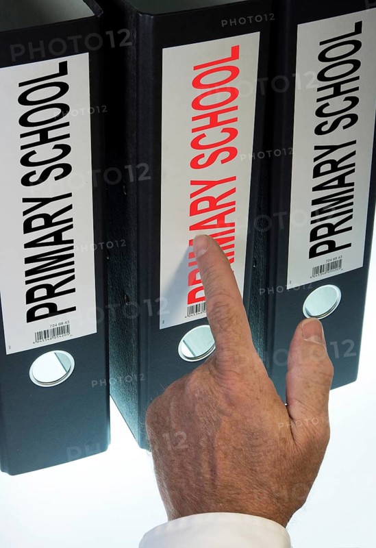 Hand pointing to a file folder labeled 'Primary School'