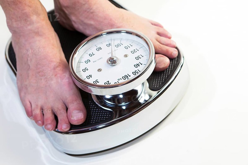 A man standing on bathroom scales