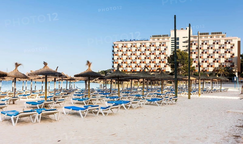 Section of beach near Palma Nova with sunbeds and hotels