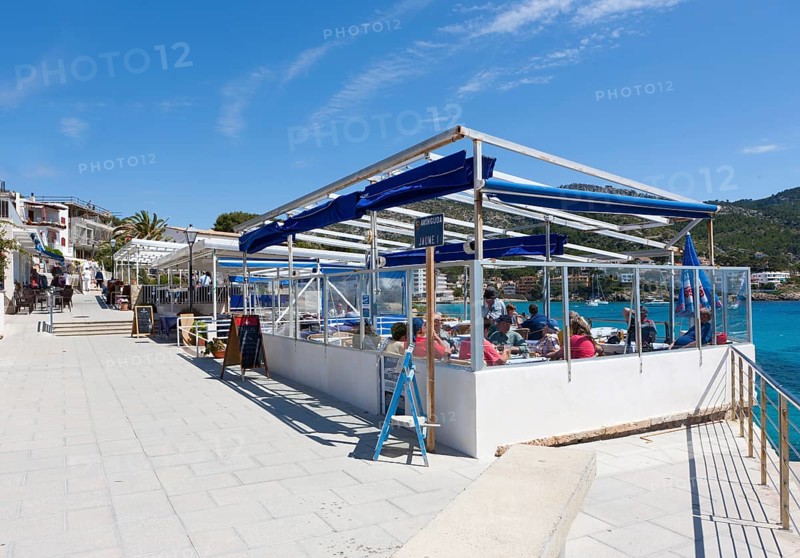 Outdoor restaurants with tourists in Sant Elm