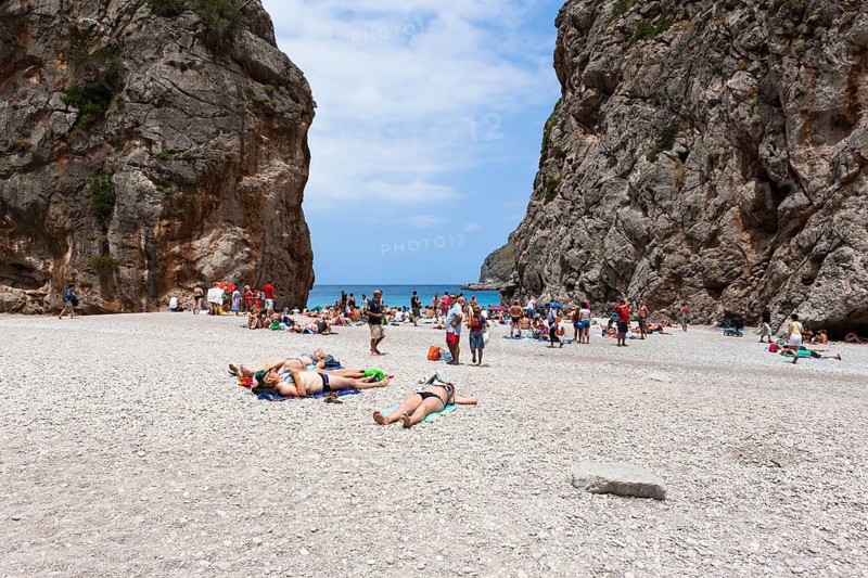 Tourists sunbathing in Torrent de Pareis Gorge