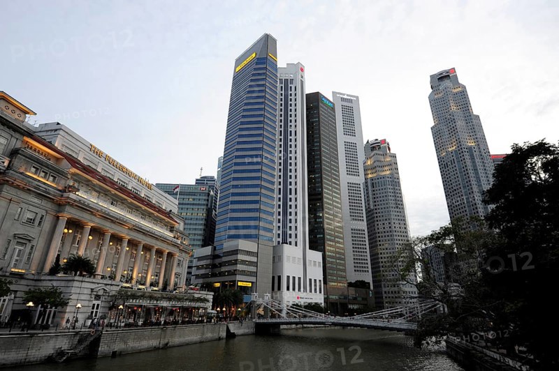 The Fullerton Hotel on Singapore River with Skyscrapers of the Financial District
