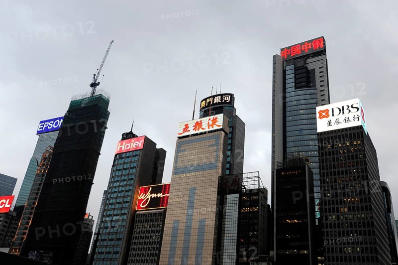 Skyscrapers and neon signs at dusk