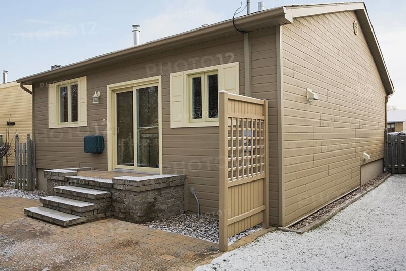 Rear view of a Residential bungalow and backyard in winter