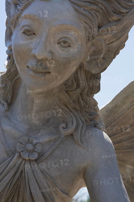Close-up of a female like statue with wings in the Fairy garden at the 'Route des Gerbes d'Angelica' garden in Mirabel