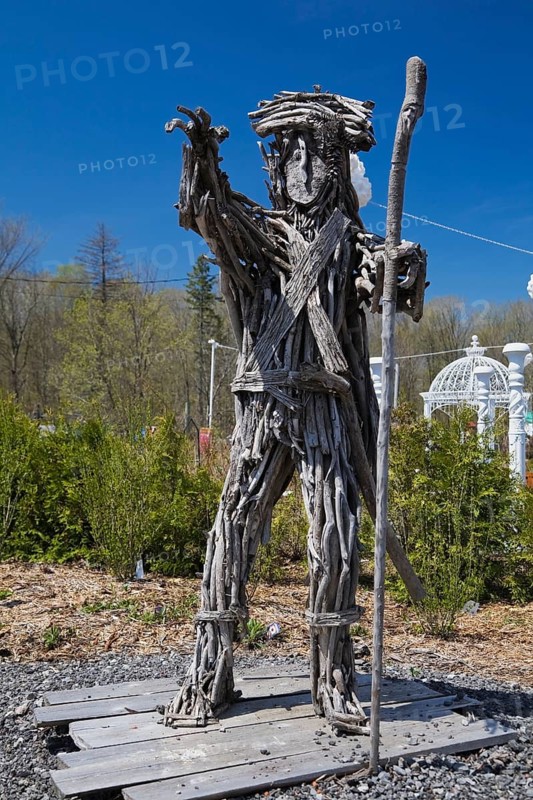 An unusual man like statue made of tree branches in the Fairy garden at the 'Route des Gerbes d'Angelica' garden in Mirabel
