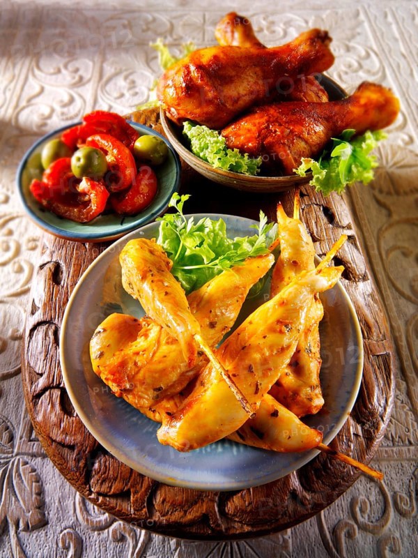 Party buffet food with chicken satay and BBQ drum sticks