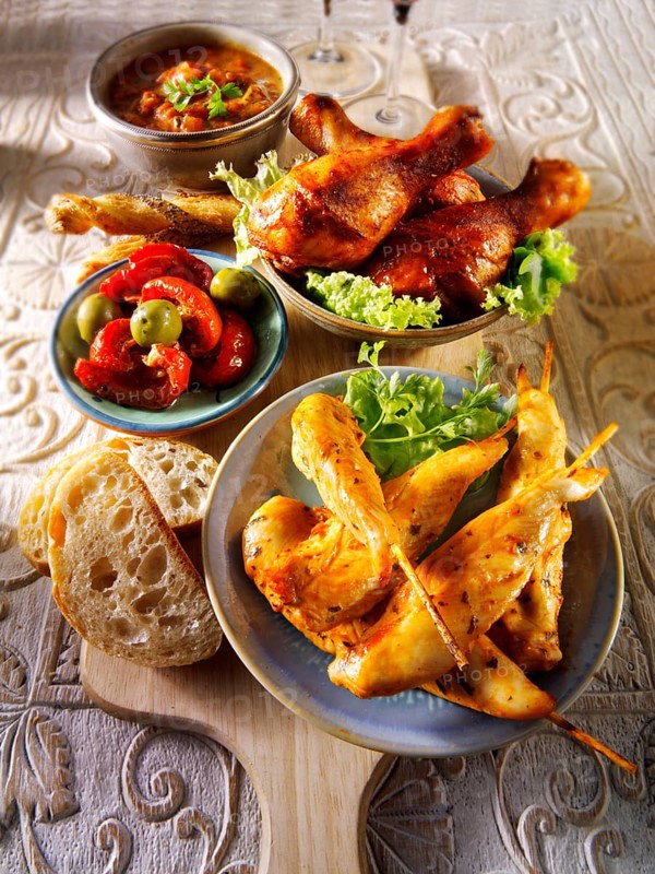 Party buffet food with chicken satay and BBQ drum sticks