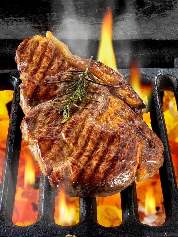 Sirloin beef steaks being cooked on a BBQ
