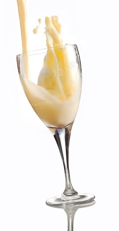 Fresh flavoured milk being poured into a glass