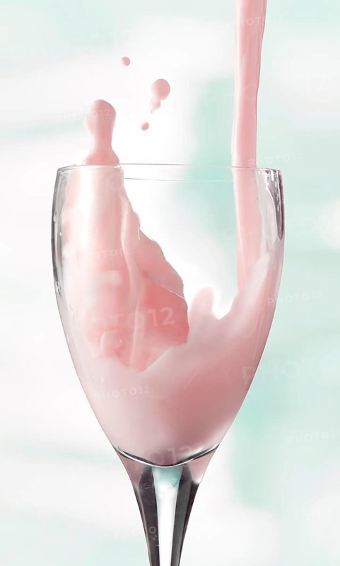 Fresh flavoured milk being poured into a glass