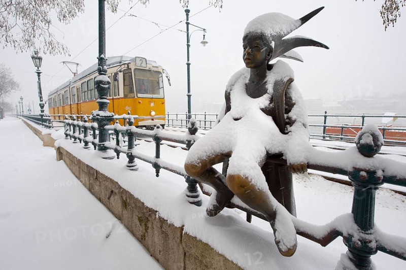 Bronze statue on the Danube Bank in the snow