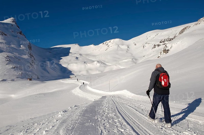 Walker in the snow in the mountains near Grindelwald First