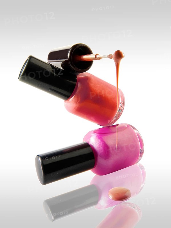 Two nail varnish bottles balanced on each other