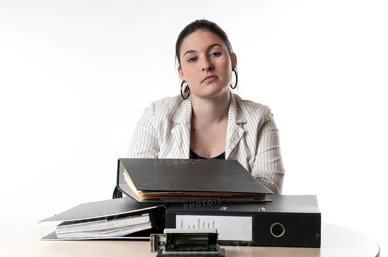 Office worker sitting at a desk with files