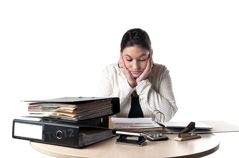 Office worker sitting at a desk with files