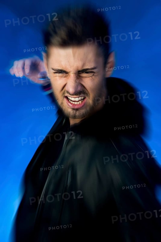 Aggressive young man with his hand prepared to strike