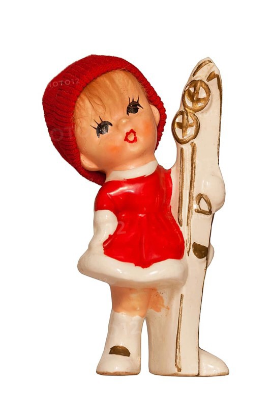 Porcelain doll with ski clothing and skis