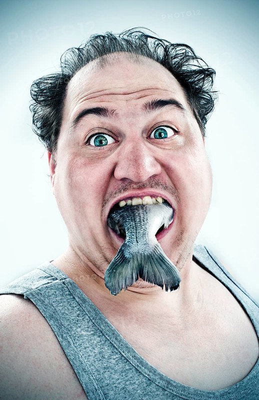 Chubby man with a fish in his mouth