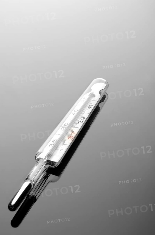 Mercury thermometer on a reflective surface