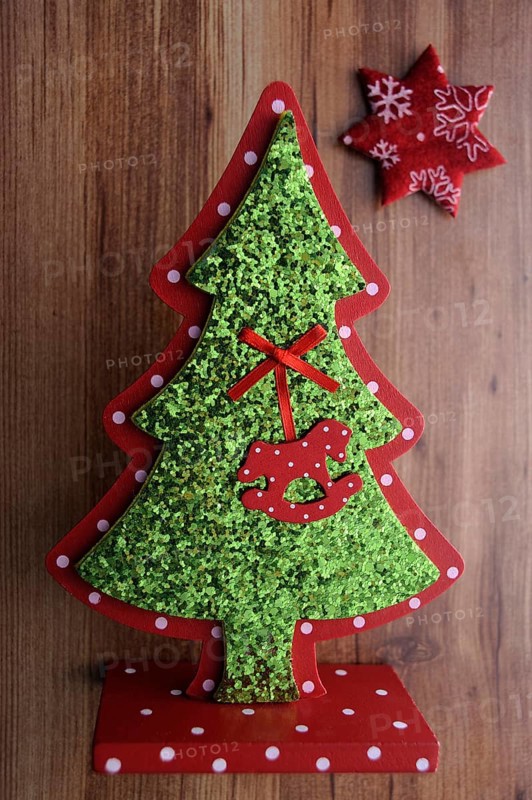 Miniature Christmas tree and a star on a wooden surface
