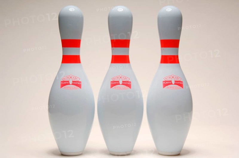 Three bowling pins lined up together