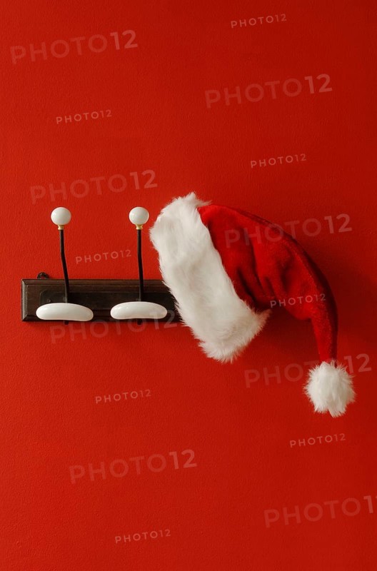 Santa Claus hat hanging on nostalgic coat hooks
